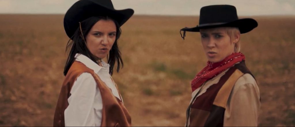 Two girls wearing cowboy costumes