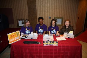Four Hospitality Volunteers Sitting at a Table