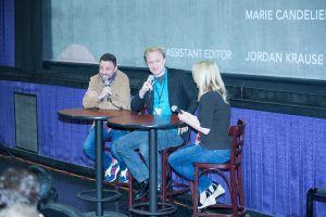 Two men and a woman with a mic in their hands