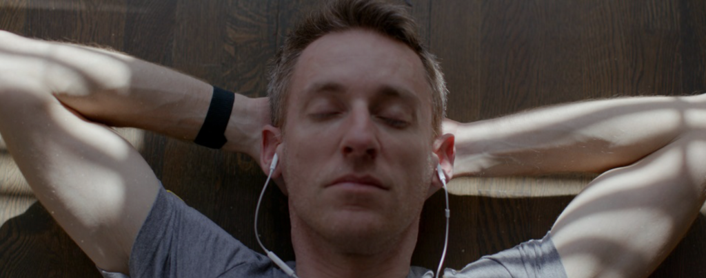 a man listening to songs with eyes closed